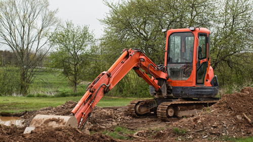 Excavator shoveling dirt